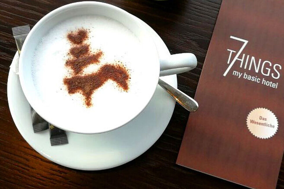 A filled coffee cup and menu on a table